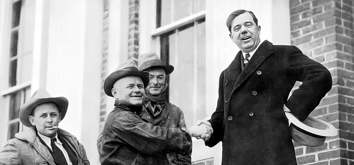 Huey Long shakes hands with constituents on the courthouse steps